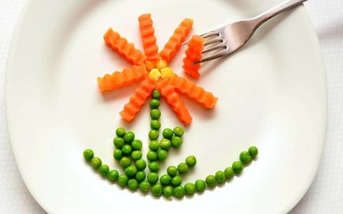 Vegetables arranged in a flower on a plate