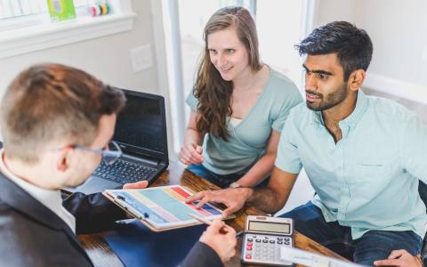 A couple talking to a real estate agent